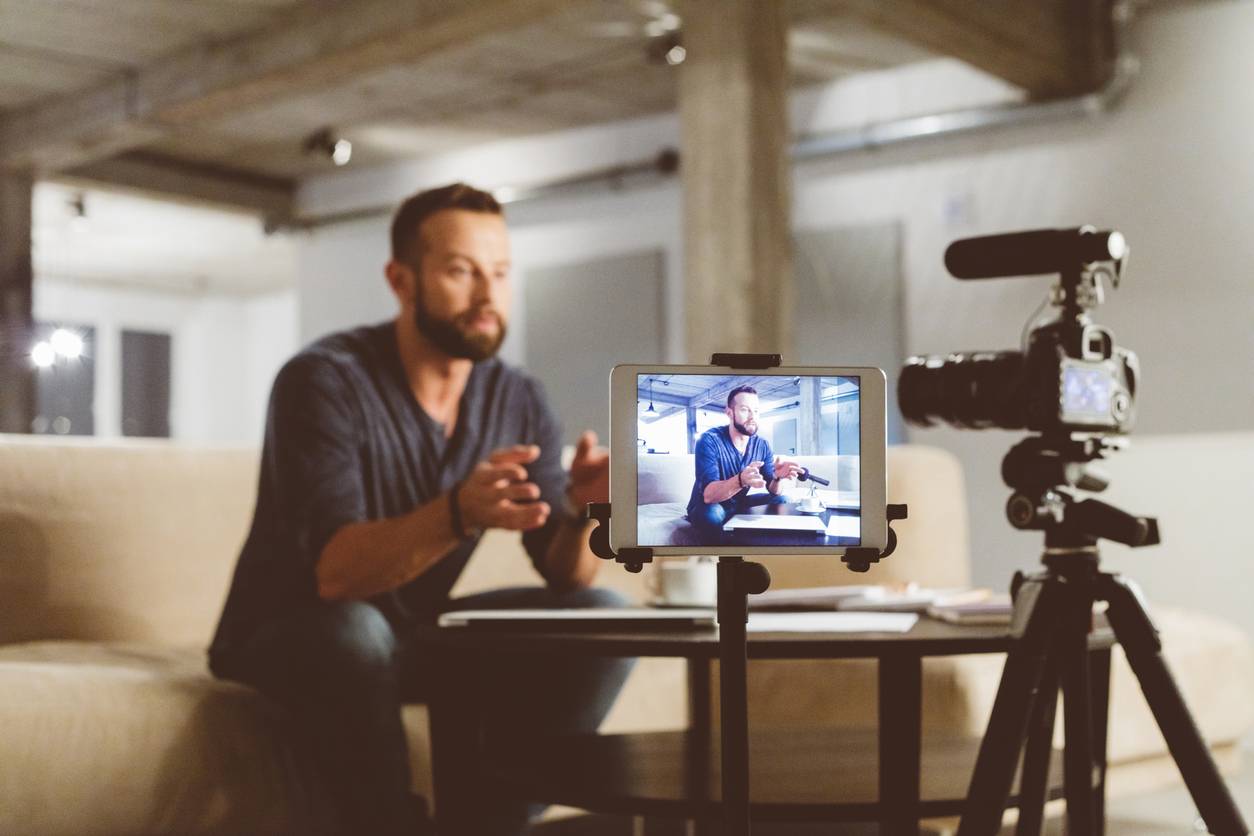 young man making a video blog